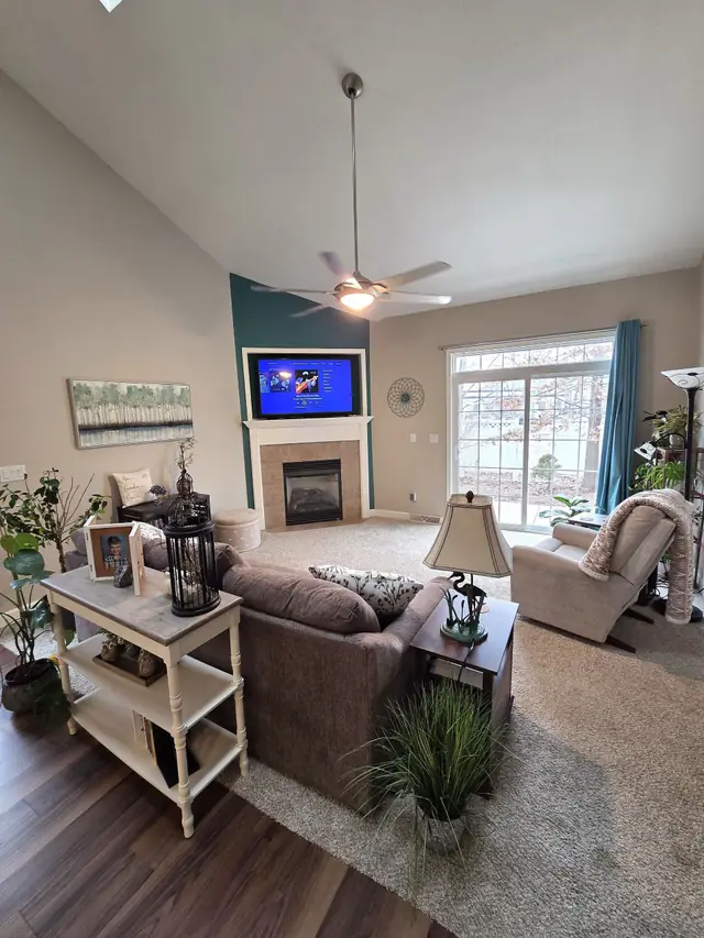 A vaulted living room with a deep teal accent wall