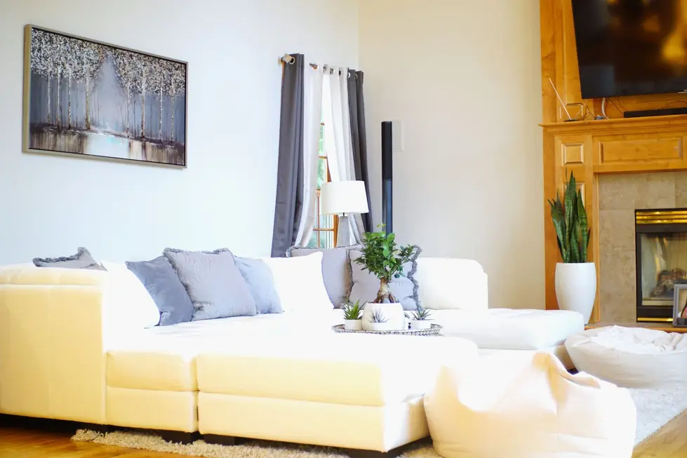 A bright living room with freshly painted walls and a white sectional sofa