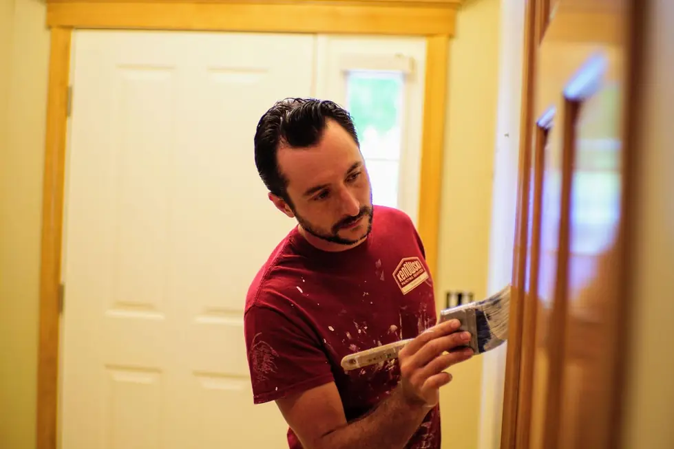 A Kenowski painter cutting in a clean line along a door frame